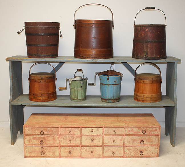 More country & primitive painted furniture including bucket bench in blue & set of drawers in red shown with some of the buckets.