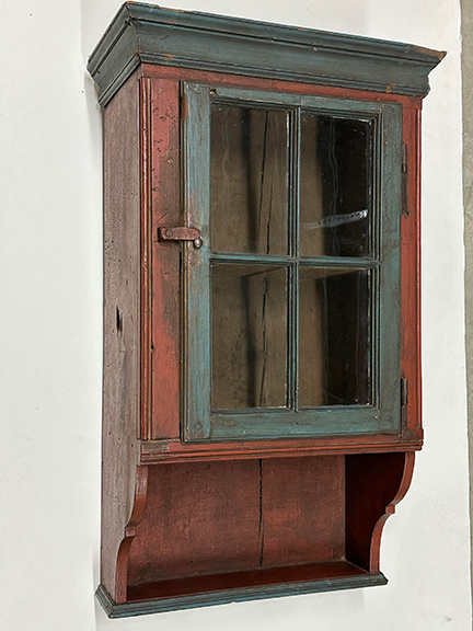 A Pennsylvania hanging cabinet in old paint.