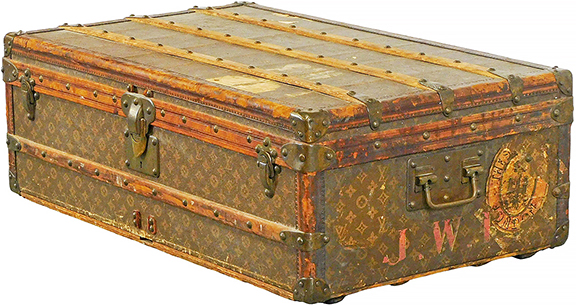 Louis Vuitton cabin trunk, early 20th century, serial no. 135688, monogram pattern exterior, red monogrammed initials &ldquo;J.W.I.,&rdquo; remnants of stickers including New York and London, brass hardware, white cloth-lined interior, missing interior tray, &ldquo;Bond Street&rdquo; label bottom right interior of lid, 12&frac12;
