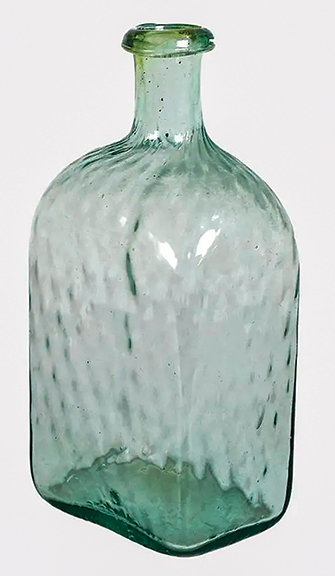 The body of this light aqua/green blown glass bottle from the first half of the 19th century displays an overall diamond quilted pattern. The rim is applied, and there is a noticeable pontil mark. The bottle stands 10