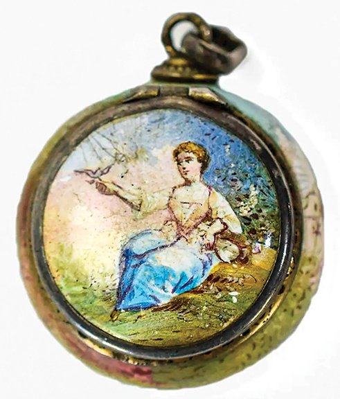 The lid of this Austrian 19th-century hand-painted silver and enamel vinaigrette shows a seated young woman feeding a bird. The back is painted with the same woman, having been joined by a man, and romance is implied. The underside of the lid displays the face and wings of a cherub. The vinaigrette is 1