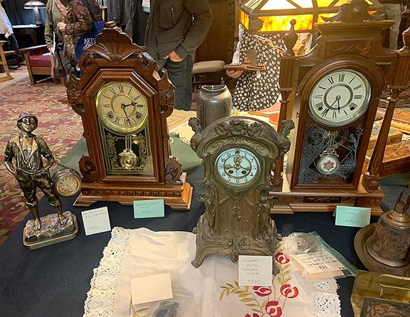 Mark and Jean Oberkirsch of Hillsboro, Missouri, brought a number of clocks, even though Mark said, “They’re hard to sell because the younger generation just doesn’t care.” Still, in the first few hours, he sold a small Ansonia Clock Company piece with a reclining figure “watching time go by,” not shown, for $225. Among those remaining were “The Whistler,” a brass-plated timepiece, also by Ansonia, for $475; a carved walnut shelf clock by E. Ingraham Clock Co. for $150; a nickel-plated Ansonia clock with a glass pendulum and atypical base for $350; and a cast-metal clock by William L. Gilbert with a porcelain dial featuring a five-pointed star for $475.