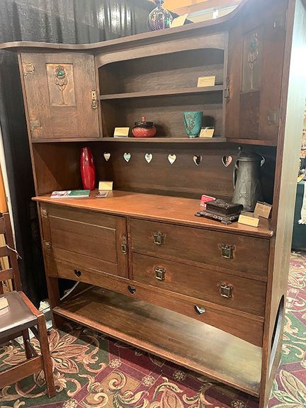 This large one-piece sideboard was offered by Tommy McPherson of Uncommon Artifacts Estate Services LLC, Mobile, Alabama, for $9500. Made of quartersawn oak, it was built by Bath Cabinet Makers Co. Ltd., Bath, England, around 1901-02. McPherson said the guild was  composed of blue-collar workers who had been laid off but built furniture for international exhibitions. The doors feature enameled designs in the Liberty style. Among the pieces displayed on the sideboard are a pewter tankard for $750 and a Scottish glass dresser box by Monart for $1250; from the 1920s to ’30s, the box is the only known example of this design, McPherson said.