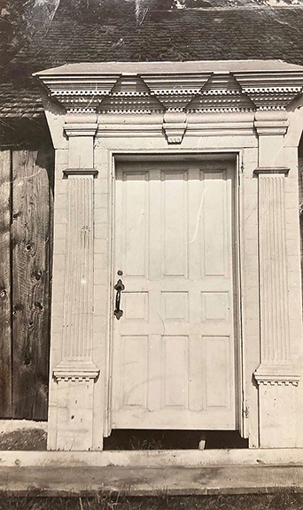 Eighteenth-century Connecticut Valley door surround, the pine frame components consisting of a rusticated surround with pilasters with fluted columns, an architrave, and a pulvinated frieze, surmounted by a dentiled cornice, outer dimensions 114