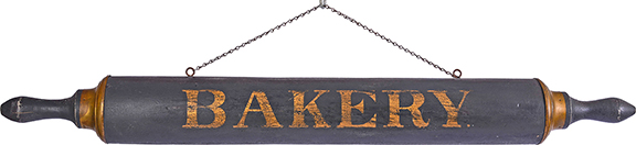 A wooden trade sign in the form of a full-dimensional oversized baker&rsquo;s rolling pin, 48