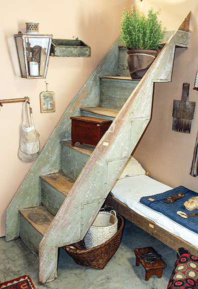 Staircase in green paint, said to be out of a log cabin in Tennessee or Kentucky, $650 from Sherry Baggett of Humble & Worn, Springfield, Tennessee. The miniature blanket chest on the steps, pine with strap hinges, was $295; the candle lantern, $425; and the hanging candle box in blue-green paint, $265.