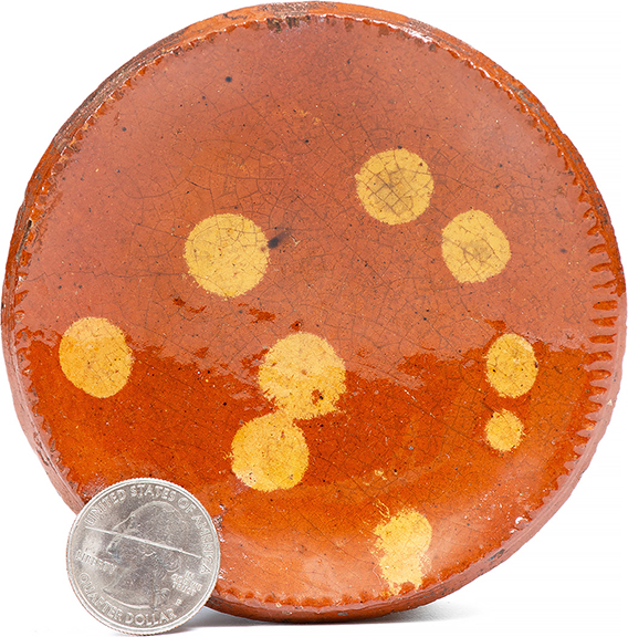 This Pennsylvania dotted redware tart plate, 3 7/8