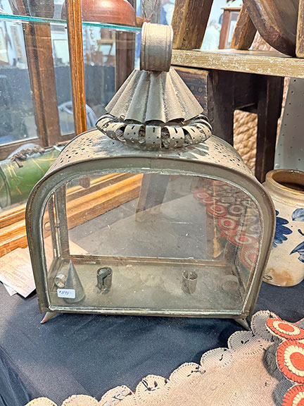 The tin and glass double-candle lantern, probably Continental, early to mid-19th century, from Colleen B. Alpers of Cedar Rapids, Iowa was $895. Alpers said she had never seen another like it. The snuffer is a replacement.