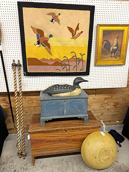This colorful Grenfell weaving of ducks in flight was tagged $950 by Nancy and Craig Cheney of Mansfield, Ohio. The carved and painted loon, signed &ldquo;JB,&rdquo; was $495; the small blue painted blanket chest was $2100; the larger blanket chest with original paint decoration was $950; and the 19