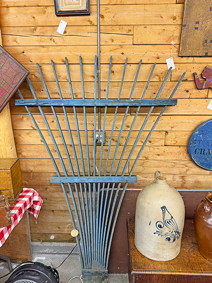 This late 19th-/early 20th-century trellis in its original blue paint was $800 from Cooper O&rsquo;Connell of Gilded Goose Antiques, St. Albans, Vermont. The five-gallon stoneware jug depicting a bird with a large chest was $500.