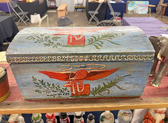 The paint-decorated dome-top box by band box makers Putnam and Hoff of Hartford, Connecticut, features an eagle with a banner reading &ldquo;Putnam and Hoff Paper Hangers.&rdquo; Erb&rsquo;s Antiques, Lancaster, Pennsylvania, tagged it $2995.