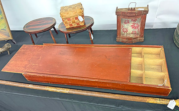 7  This large 19th-century slide-lid box seed box in original red paint was $495 from Ken and Robin Pike of Nashua, New Hampshire. In an email, the Pikes wrote, &ldquo;Despite the torrential rains, we had a very good show. Sales were very close to past years, which was our goal. We sold twenty items. We felt the gate was lighter because of the weather, but it didn&rsquo;t matter as far as we were concerned. The serious buyers still showed up.&rdquo;