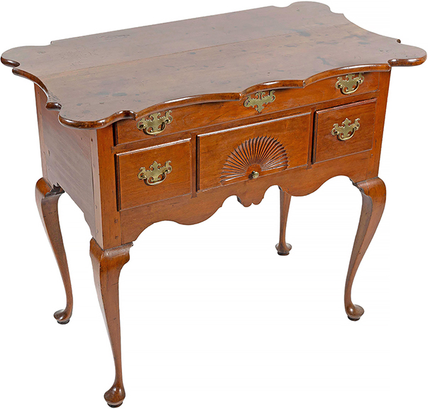 This Connecticut Queen Anne cherry dressing table with a scalloped top from the Wethersfield area is rare and important. It was made around 1750 with out-rounded corners, scalloped on three sides, with a full width drawer over three smaller drawers, the central one with a carved fan, and a scrolled apron. It exhibits traits associated with the Wethersfield school: the fluidity of the skirt, the carved fan style, canted knee brackets, and truncated pads on the feet. It was estimated at $25,000/50,000 and realized $189,000. The table was discovered in Clinton, Connecticut, in 1945 by Betty H. Richmond and her husband; a letter from Mrs. Richmond on the letterhead of William&rsquo;s Antique Shop in Old Greenwich, described how she and her husband discovered the piece. It sold at Christie&rsquo;s Americana sale, January 23, 1988, to John Walton, Inc. for $82,500; then to the collection of Thomas and Alice Kugelman of Hartford; to Marguerite Riordan, of Stonington, 1999; to the collection of Nancy and Larry Dickson. The table was published in Connecticut Furniture: Seventeenth and Eighteenth Centuries by Henry P. Maynard (1967).