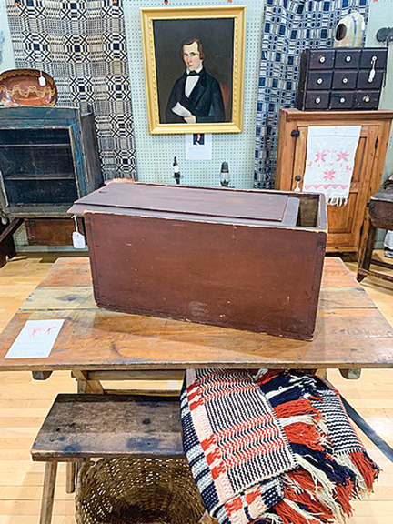 The large red slide-lid box was $495, and the sawbuck table, $650. The table came from the Irwin family of Millsboro, Virginia. The portrait in the background, signed “Metcalf 1843,” was $650. All were from Lynn LoPresti of Hickory Springs Antiques.
