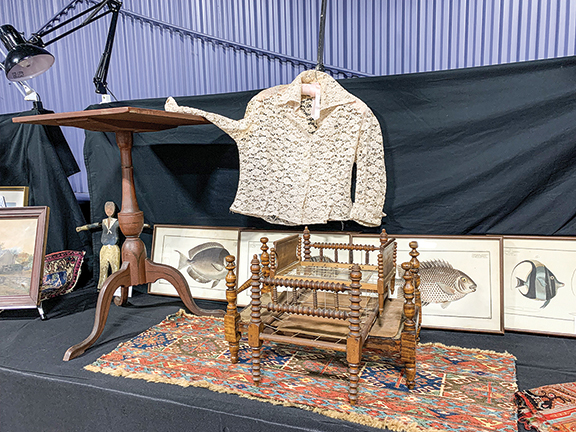 This arrangement of a candlestand with a clothing article partially draped on it said “come look at me,” and we did. We inspected the late 18th-century fish pictures, four for $1400, and the sailor whirligig, $550, all from Michael Haskins of Palmyra, New York.