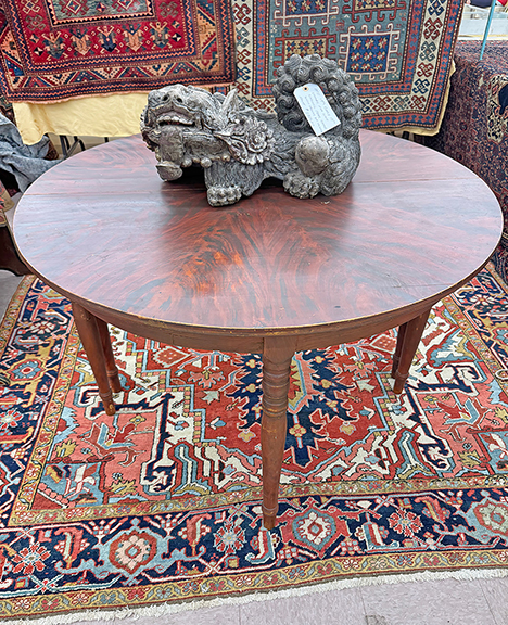 These two grain-painted demilune tables, circa 1830, possibly Maine, were being sold together for $1800 by Thomas Degnan of T.G. Degnan Curated, Ashford, Connecticut. The late 18th-/early 19th-century foo lion carving from China with traces of original paint was tagged $1750.