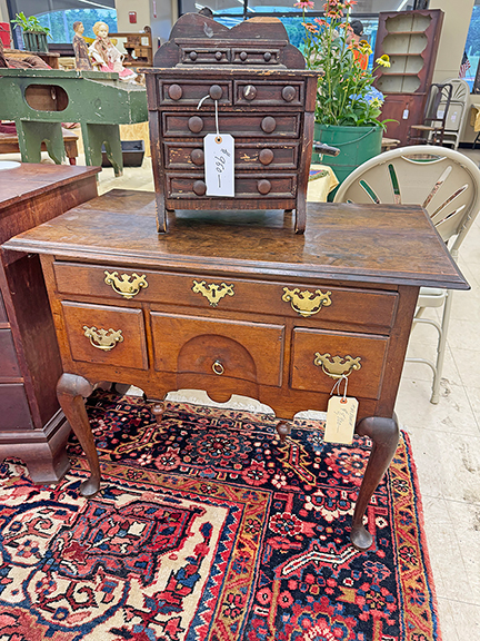 The 1740-60 Springfield, Massachusetts, cherry dressing table was tagged $8900, and the grain-painted miniature Empire chest on top, 1820-40, was $950. The booth belonged to the show promoter, Stephen Cyr, who had the chest on consignment from a private collector.
