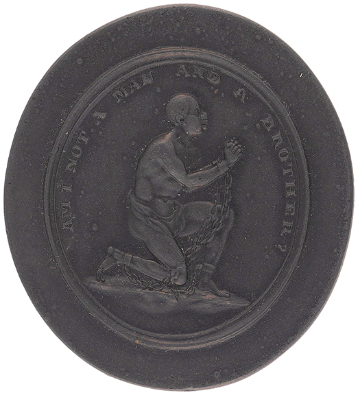 This late 18th-/early 19th-century Wedgwood black basalt oval medallion was designed by Josiah Wedgwood and others for the Society for the Abolition of the Slave Trade in 1787. Marked &ldquo;Wedgwood,&rdquo; it depicts an enslaved man pleading for humanity. Text above him reads &ldquo;Am I Not A Man And A Brother?&rdquo; Measuring 1&frac12;