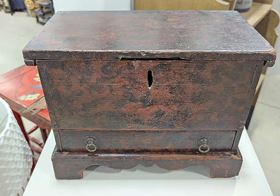 Ernie Slucher had this lovely Coshocton, Ohio, miniature blanket chest priced at $2200. The mid-1800s piece has a wonderful smoke-decorated surface, a single drawer, and a cutout base.