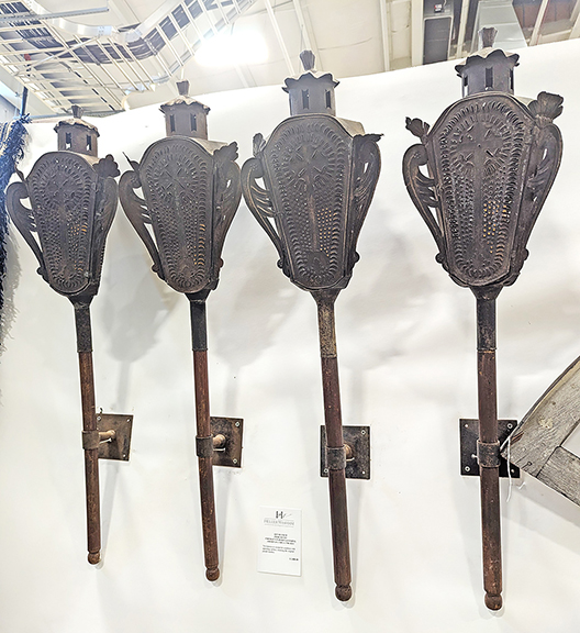 The outer wall of the dealer space of Heller Washam Antiques, Portland, Maine, featured this set of four pierced-tin firemen’s parade lanterns priced at $2800. These Americana items from between 1790 and 1825 have a lovely patina and retain their original handles.
