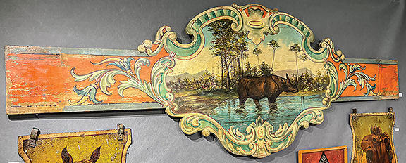 This circa 1910 carousel rounding board fragment with a rhinoceros wading in a tropical landscape was $7500 from Tambor Art and Antiques, New York City. A note said it was from the Tony Orlando collection. 