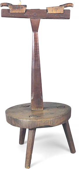 Unusual early lighting device, probably New England, 18th century, mixed woods including maple, the tripod base having a chamfered standard holding a fixed cross piece supporting two curly maple candle holders with handles, 30