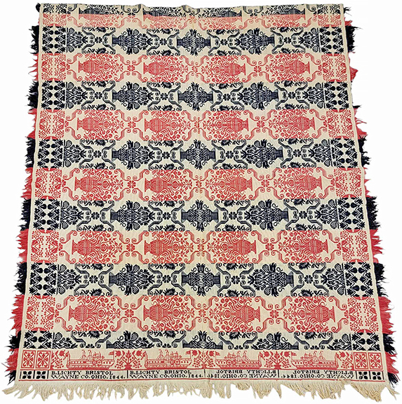 Ohio steamboat coverlet in red, blue, and natural, marked for weaver Benjamin Lichty of Bristol (now Marshallville), Wayne County, Ohio, dated “1844,” the border on one end showing four side-wheel steamers, floral field, 85¾