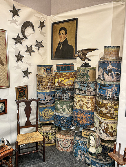 “You can have your own Shelburne,” Douglas Jackman joked about all the decorated hatboxes stacked in the booth of Stephen-Douglas Antiques, Walpole, New Hampshire, and Rockingham, Vermont, referring to Electra Havemeyer Webb’s collection of rare hatboxes at the Shelburne Museum in Shelburne, Vermont.