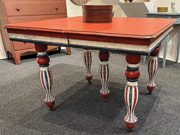 A red, white, and blue table, $1450 from Michael Whittemore Antiques & Folk Art, Punta Gorda, Florida. It has two additional leaves.