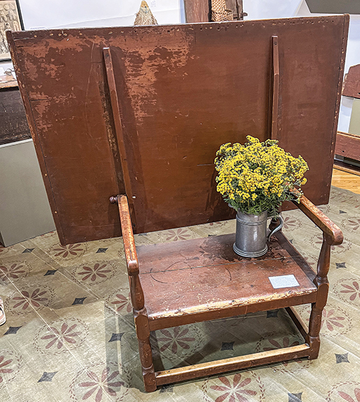 Early 18th-century William and Mary pine and maple lift-top tavern table, with a one-board top with breadboard ends, turned legs, a scrubbed top, and a dry red-painted surface, $6500 from Sharon Platt Antiques, New Castle, New Hampshire.