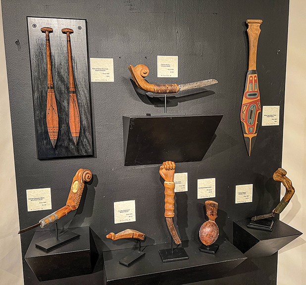 Cherry Gallery, Damariscotta, Maine, offered an enticing display of crooked knives and Native American objects. Top, from left: a pair of Native Aleutian canoe paddles, circa 1880, was $950; a carved scroll crooked knife, circa 1900, $1500; and a model Northwest Coast canoe paddle, circa 1900, $450. Bottom, from left: a carved crooked knife with a photo inlay, circa 1880, was $2200; a figural Penobscot basket gauge, circa 1870, $4500; a figural hand crooked knife, circa 1890, $1750; an incised Algonquin ladle, 18th century, $9500; and a figural female crooked knife, circa 1860, $3750.