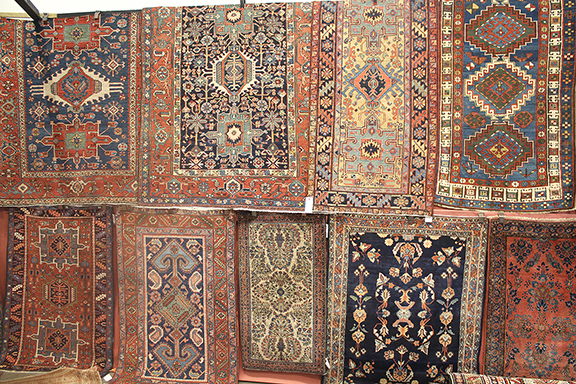 Frank Shaia of Shaia Oriental Rugs, Williamsburg, Virginia, arranges his booth to display his rugs as works of art. Shaia decorated this wall with Heriz, Kazak, and Sarouk examples. Those shown here ranged in price from $500 to $7500.