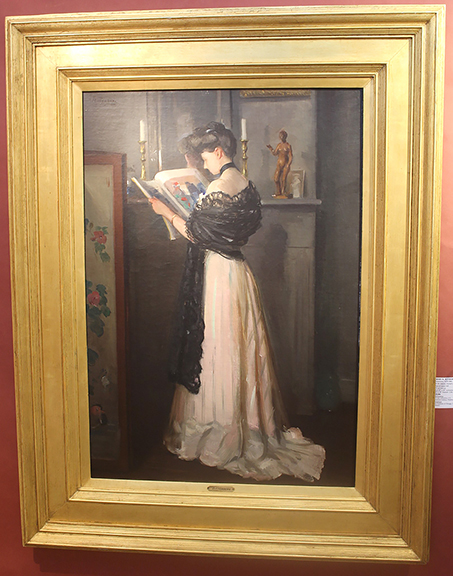 This large oil on canvas portrait of an unidentified woman reading from a large-format magazine is by Latvian/American artist Henry R. Rittenberg (1879-1969). The painting was first exhibited in Chicago in 1908. Over time it has been referred to as At the Mantel and Portrait of a Lady. Guarisco Gallery, Washington, D.C., offered the 36¼