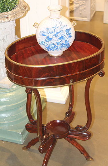 This Italian mid-19th-century mahogany table was found in the booth of The Ann Parke Collection, Darien, Connecticut. The oval top is recessed and has a single locking shallow drawer below. The top is supported by carved supports that attach to a lower stretcher that features a concave plateau. It is raised on legs that terminate in hooves. Standing 26½